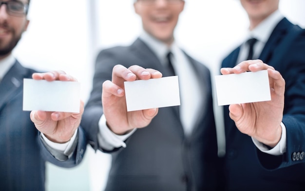 Group of young entrepreneurs showing their business cards