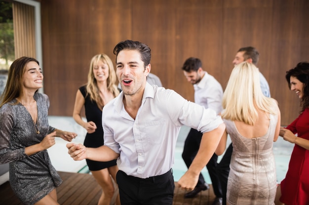 Group of young friends dancing at the party