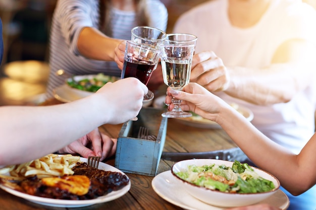 Group Of Young Friends Enjoying Meal In Restaurant