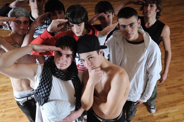 Photo group of young happy boys posing  together in dence studio