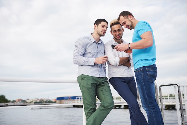 A group of young and happy men on the pier.