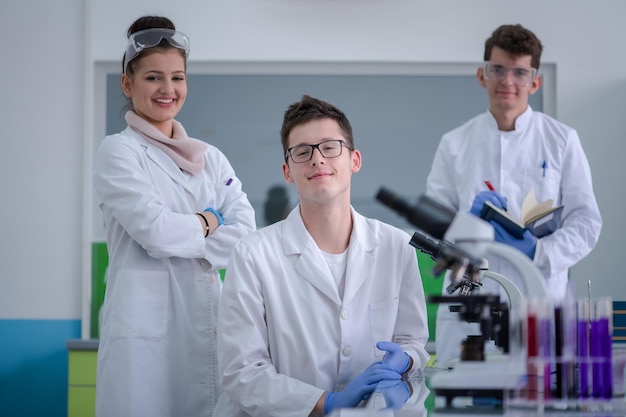 Group of young medical students doing research together in chemistry laboratory,teamwork by college student indoors