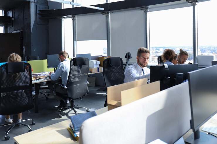 Photo group of young modern people in formalwear using modern technologies while working in the creative office.