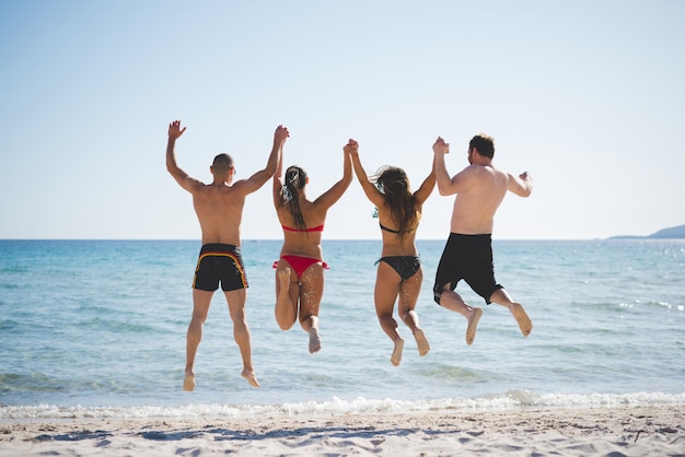 group of young multiethnic friends beach summer