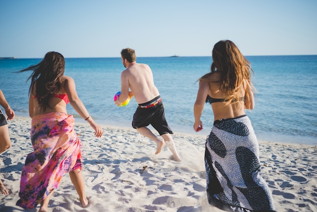 group of young multiethnic friends beach summer