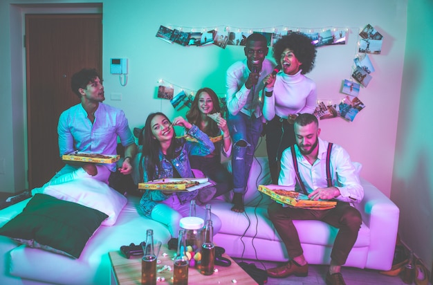 A group of young people celebrating and making party at home