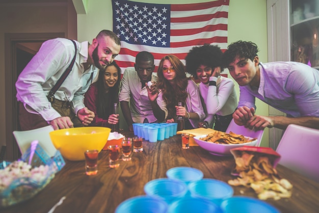 A group of young people celebrating and making party at home