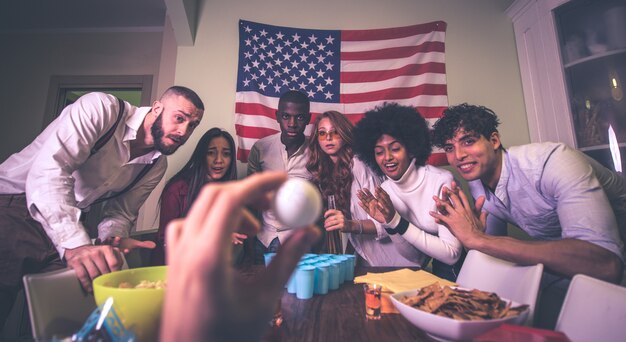 A group of young people celebrating and making party at home