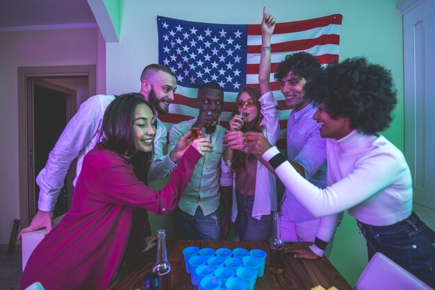 A group of young people celebrating and making party at home