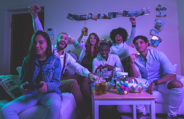 A group of young people celebrating and making party at home