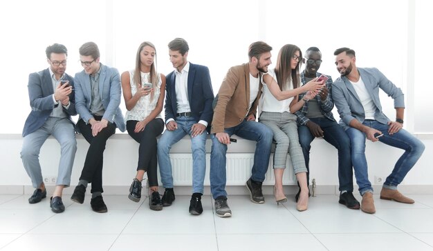 Group of young people communicate in the waiting roomphoto with copy space