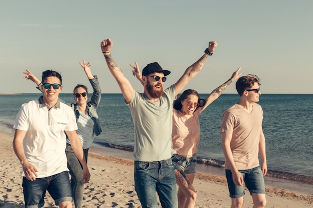 Group of young people enjoy summer party at the beach