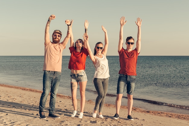 Group of young people enjoy summer party at the beach