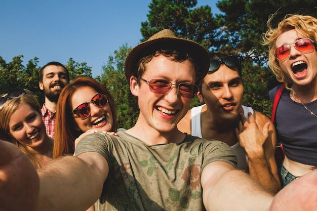 Group of young people having fun and taking selfie