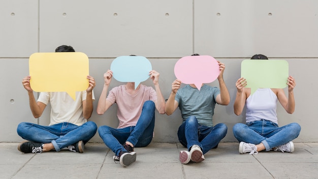 Photo group of young people holding speech bubbles