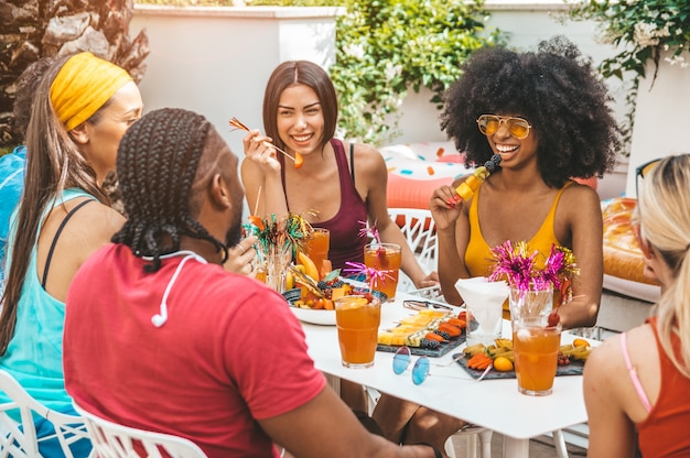 Group of young people laughing and having fun at bbq at home