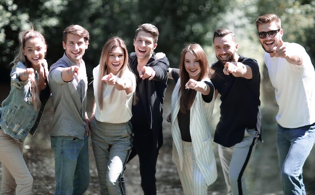 Group of young people pointing at you