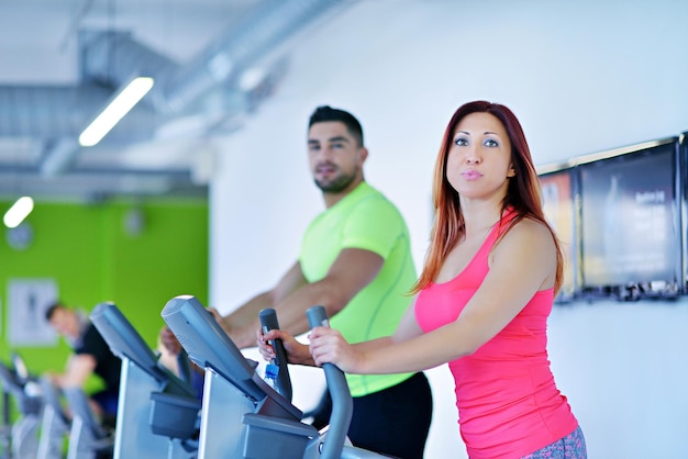 group of young people running on treadmills in modern sport  gym