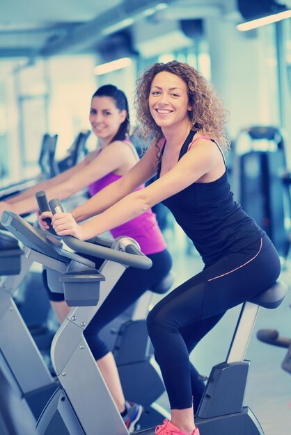 group of young people running on treadmills in modern sport  gym