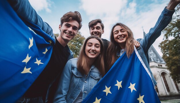 A group of young people take a selfie in the background the flag of the european union is waving