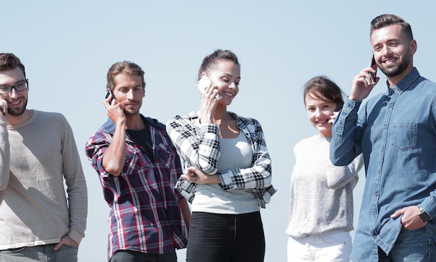 Group of young people talking on their smartphonesphoto with copy space