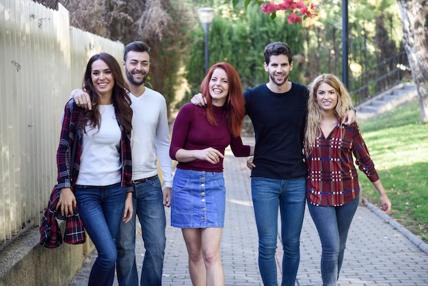 Group of young people together outdoors in urban background