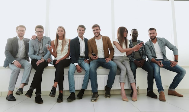 Group of young people use their smartphones