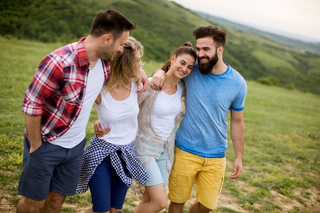 Group of young people walking in the summer field