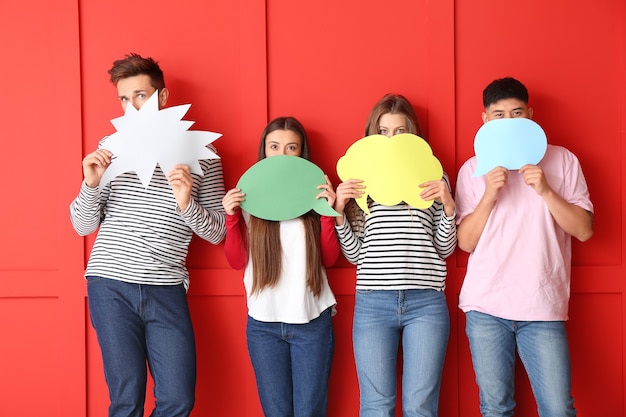 Photo group of young people with blank speech bubbles on red