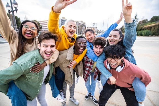 Group of young people with hands up looking at camera