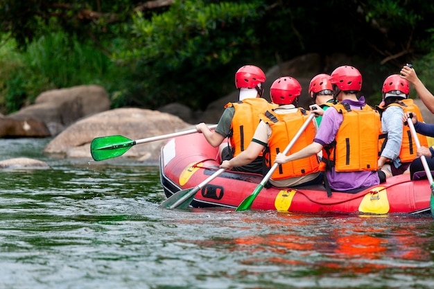 Group of young person rafting on the river