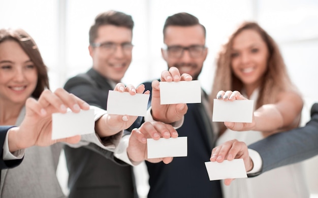 Group of young professionals showing their business cards