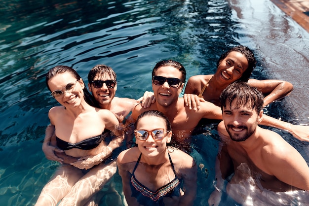 Group of Young Smiling People Wearing Sunglasses having Fun