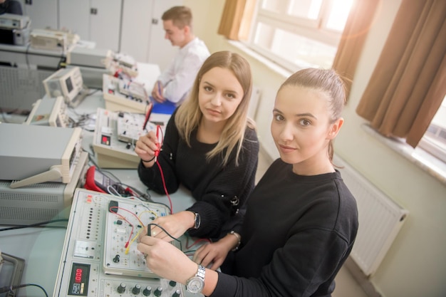 Group of young students doing technical vocational practice with teacher in the electronic classroom, Education and technology concept