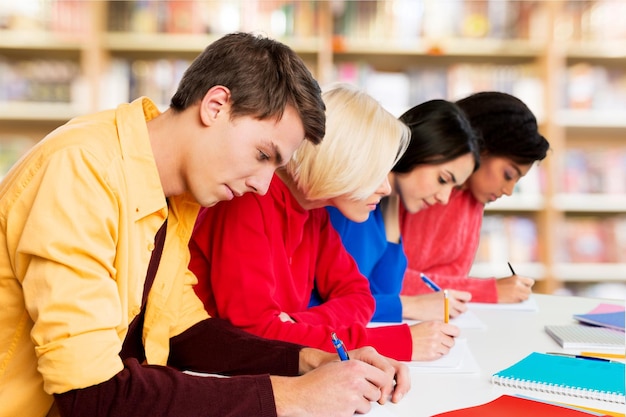 Group of young Students writing notes