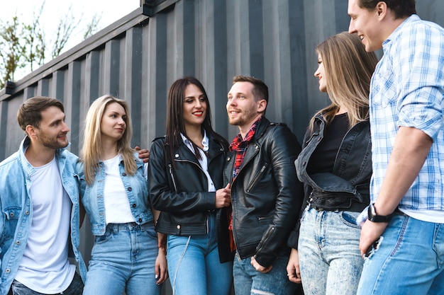 Group of young and stylish people during a meeting on a city street