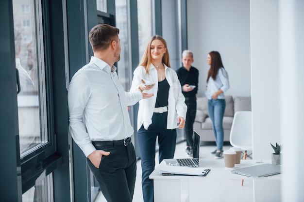 Group of young successful team that working and communicating together indoors in office