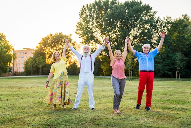 Group of youthful seniors having fun outdoors  