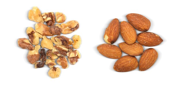 Photo groups of almonds and walnuts isolated on a white background raw natural contains clipping path