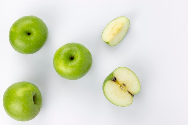 Groups of apples with cut in half slices isolated on white background