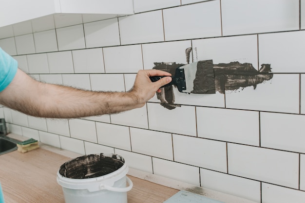 Photo grouting tiles in the kitchen. repair. tile hog