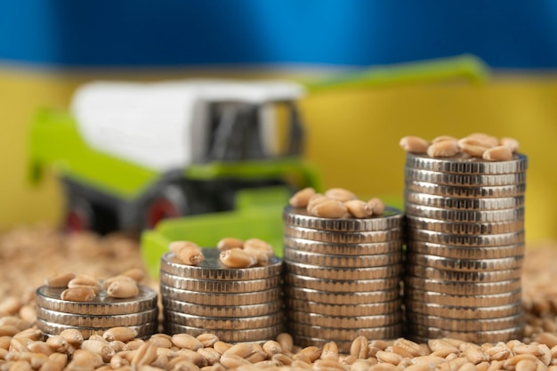 Growing money in the form of a stack of coins on the background of the Ukrainian flag and grain Wheat price grain reserves around the world Food crisis Export Logistics Solution