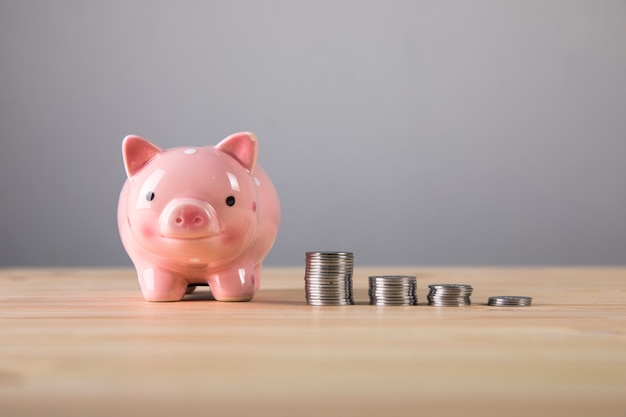 Growth of coins and a piggy bank on the table