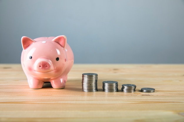 Growth of coins and a piggy bank on the table