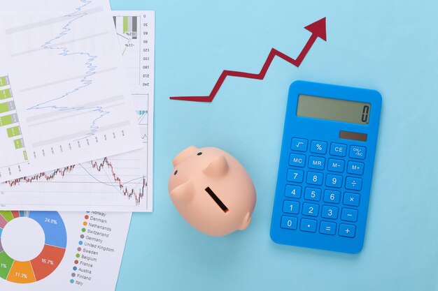 Growth upward arrow, graphs and charts, piggy bank and calculator on blue. Business success