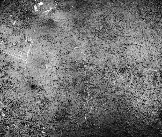 Grunge black texture The texture of the scratches on the metal Texture scratches background monochrome Rough textured hard background The surface is damaged