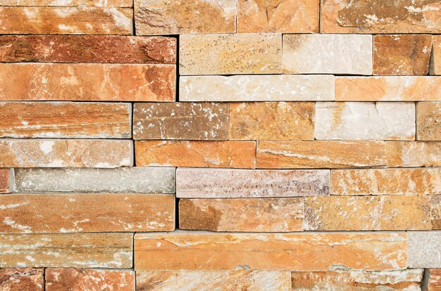 Grunge brown ,beige,orange,grey stone wall tiles texture backdrop.Wall natural brown stone dirty,dust.Wall and panel marble natural pattern for architecture and interior design or abstract background