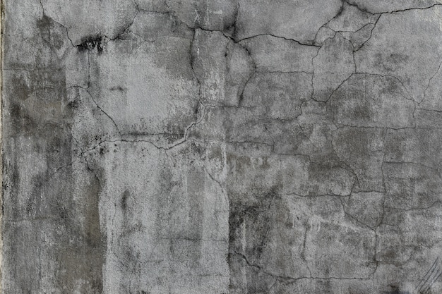 Grunge concrete wall with crack and stains. Cement texture for design and background.