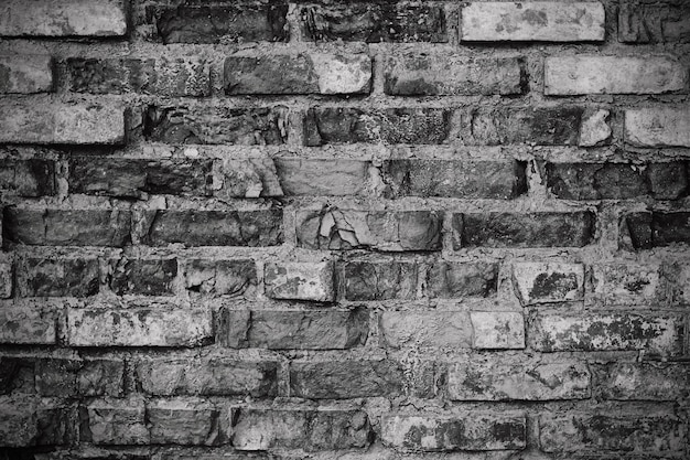 Grunge dark brick wall texture of black stone blocks