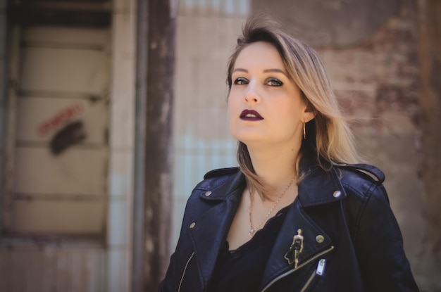 Grunge fashion portrait of stylish blonde woman, leather biker\
jacket, rock n roll mood